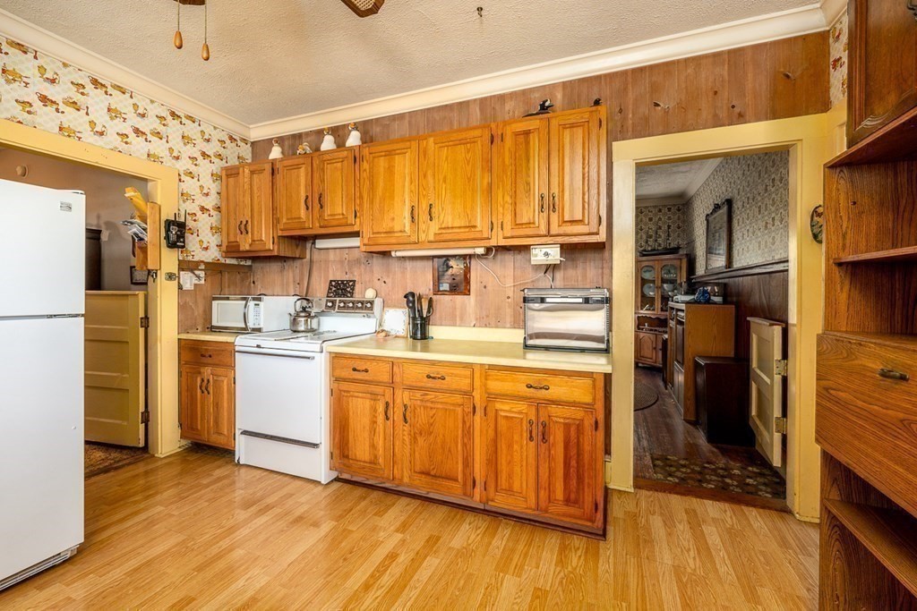 1054 County Road Bourne, MA 02534 - Photo 20 of 40 a kitchen with a refrigerator wooden floor and a view of living room