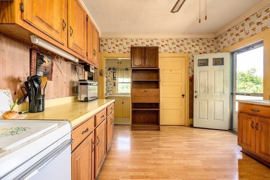 1054 County Road Bourne, MA 02534 - Photo 21 of 40 a kitchen with stainless steel appliances kitchen island granite countertop a refrigerator and a stove