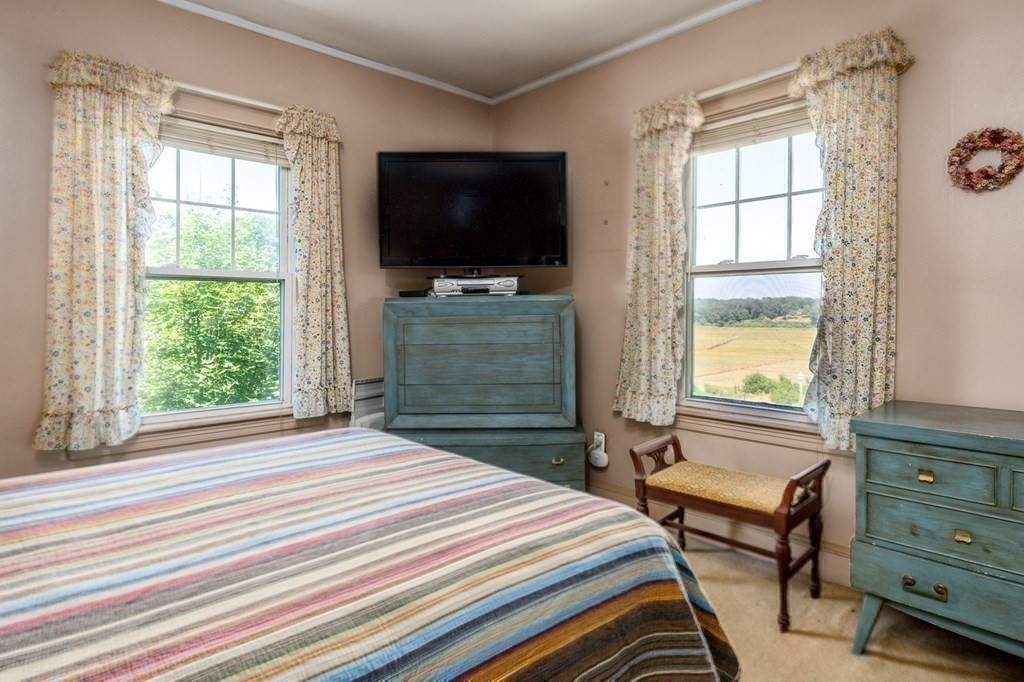 1054 County Road Bourne, MA 02534 - Photo 24 of 40 a bedroom with a bed and a flat screen tv