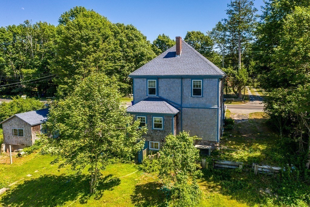 1054 County Road Bourne, MA 02534 - Photo 29 of 40 a front view of a house with a yard and trees