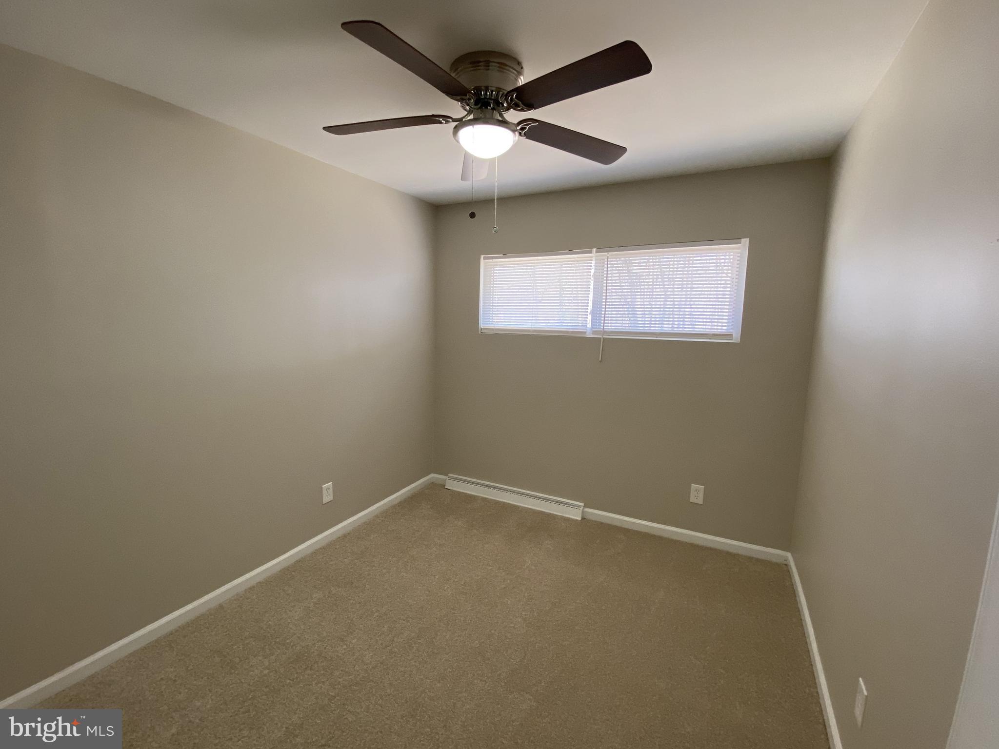 82 West Stephen Drive Newark, DE 19713 - Photo 12 of 17 an empty room with a ceiling fan and window