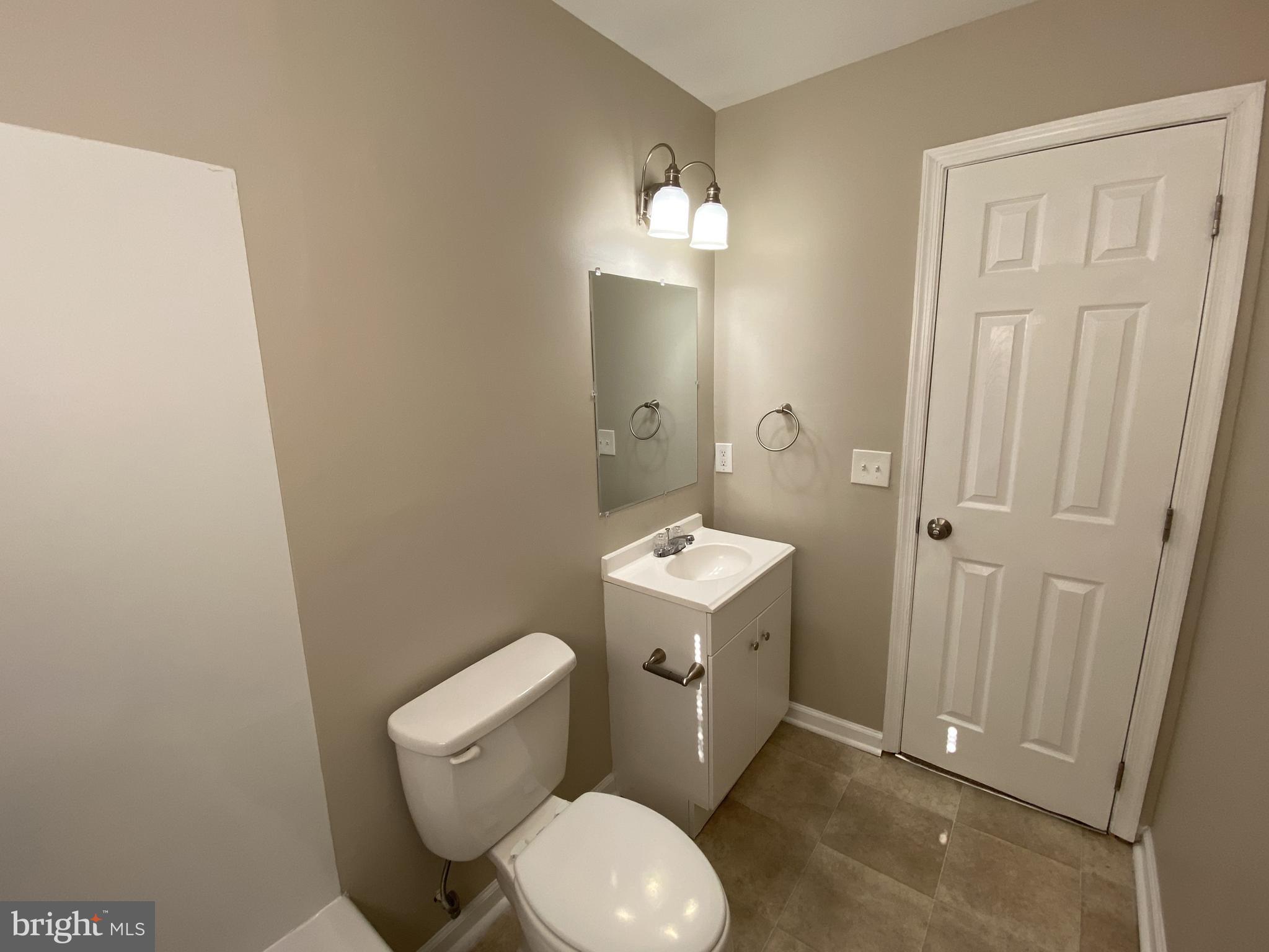 82 West Stephen Drive Newark, DE 19713 - Photo 14 of 17 a bathroom with a granite countertop toilet and a sink