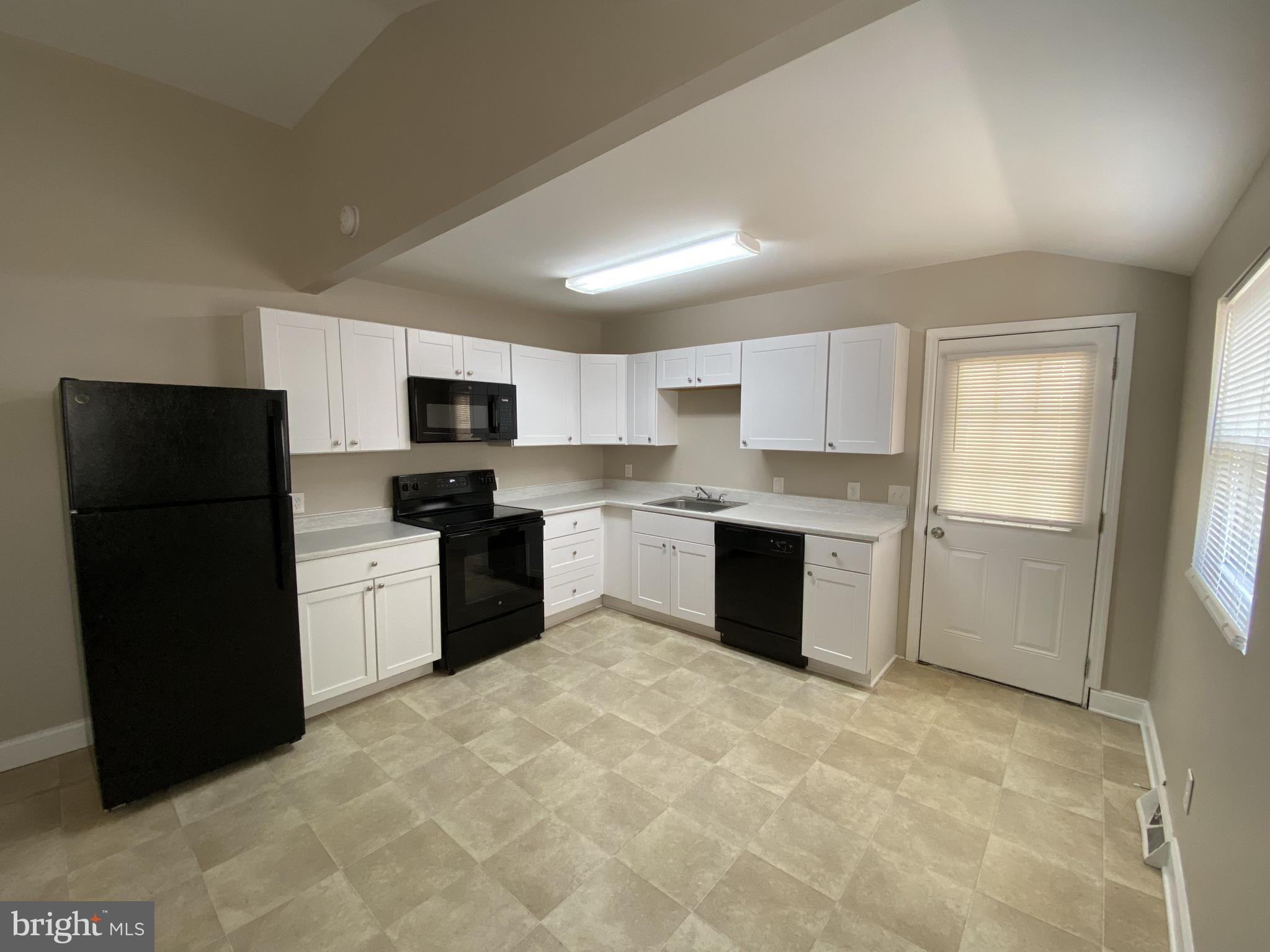 82 West Stephen Drive Newark, DE 19713 - Photo 7 of 17 a kitchen with a refrigerator and a stove