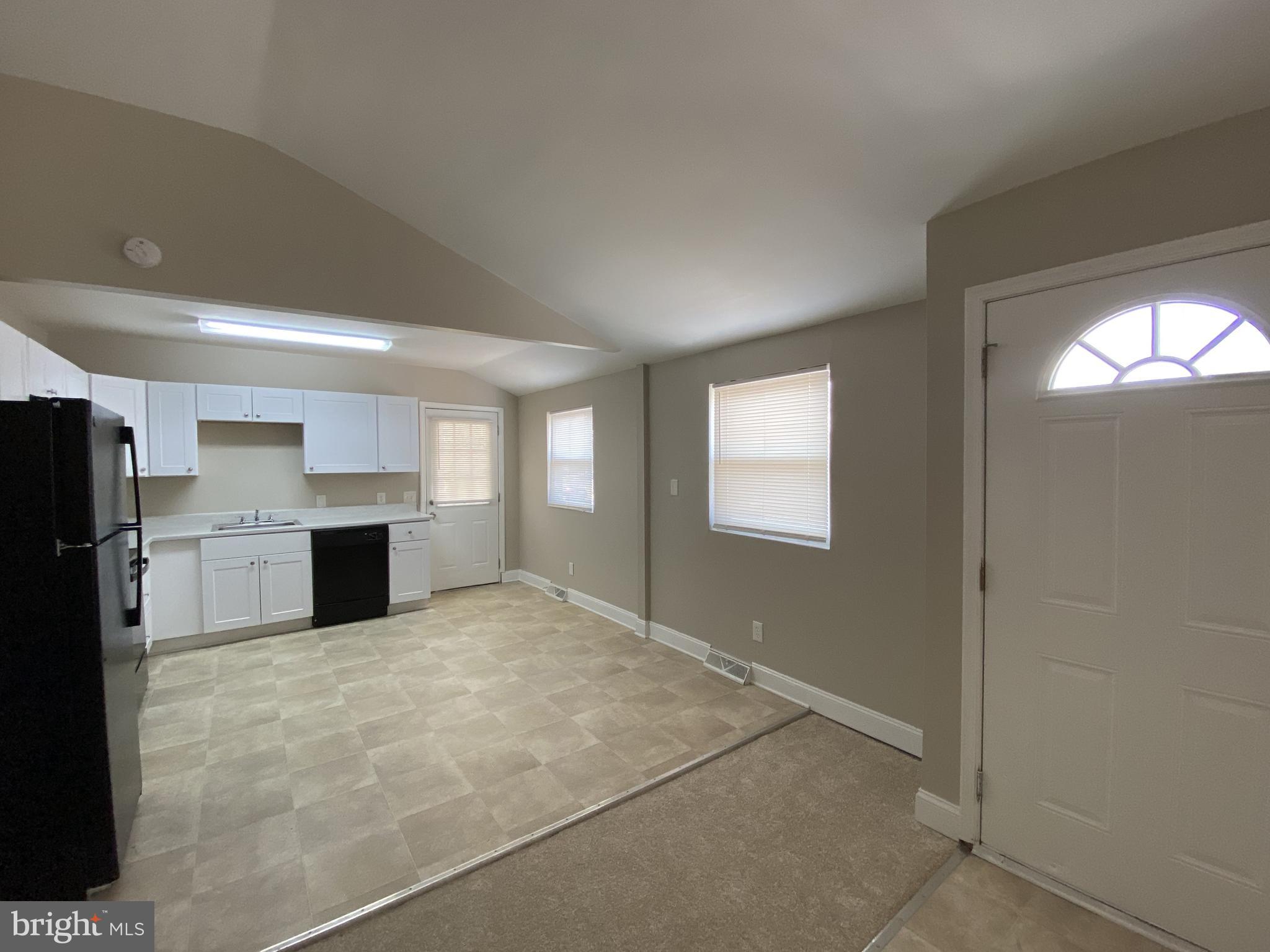 82 West Stephen Drive Newark, DE 19713 - Photo 8 of 17 a view of a kitchen with a sink cabinet a refrigerator and windows