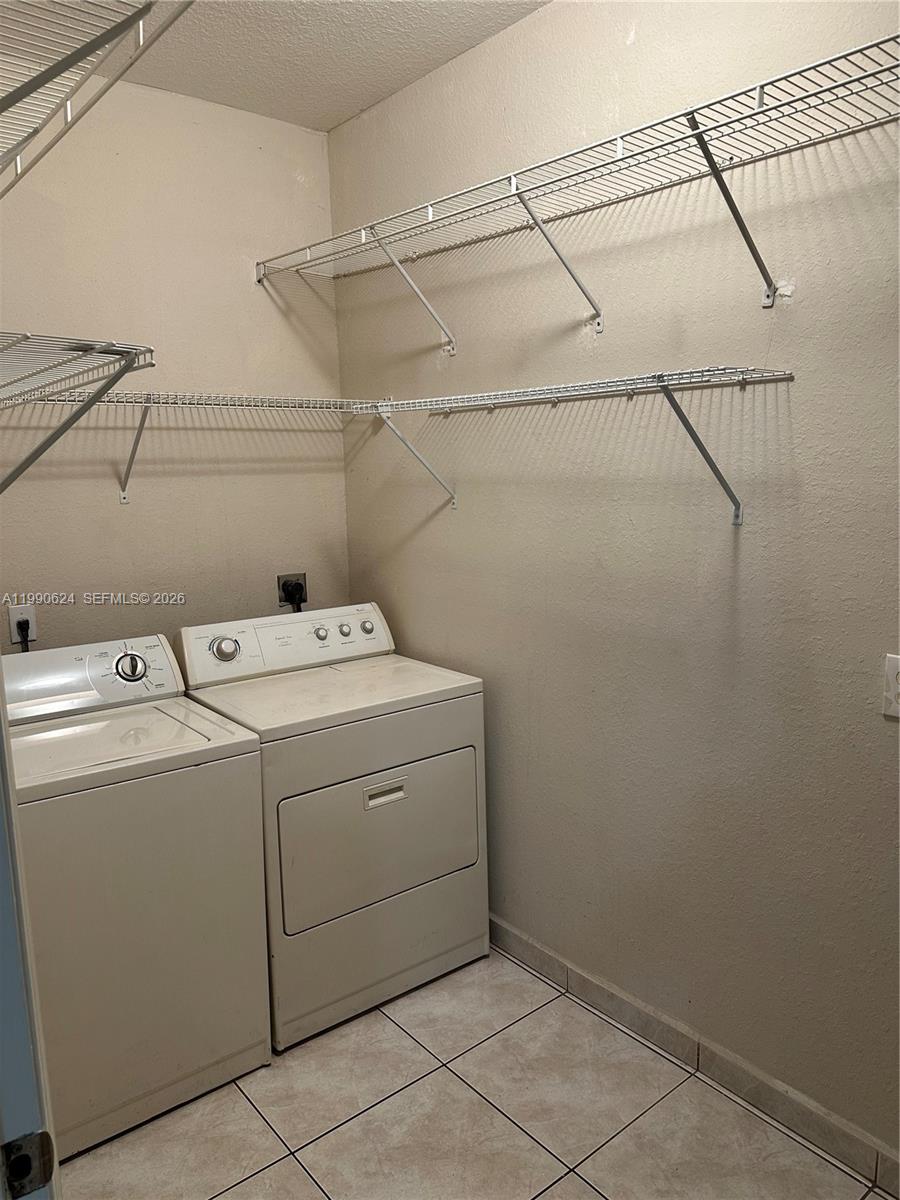 7549 Northwest 175th Street, Unit 7549 Hialeah, FL 33015 - Photo 16 of 34 a utility room with dryer and washer