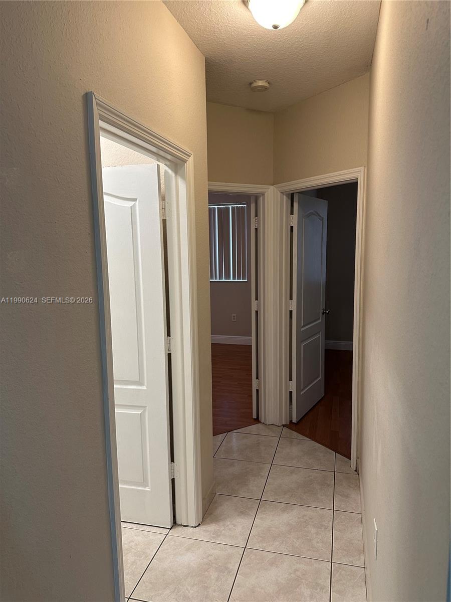 7549 Northwest 175th Street, Unit 7549 Hialeah, FL 33015 - Photo 26 of 34 an empty room with closet and a bathroom