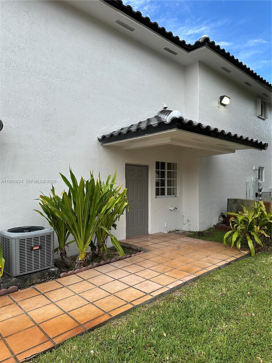7549 Northwest 175th Street, Unit 7549 Hialeah, FL 33015 - Photo 3 of 34 a front view of a house with a yard