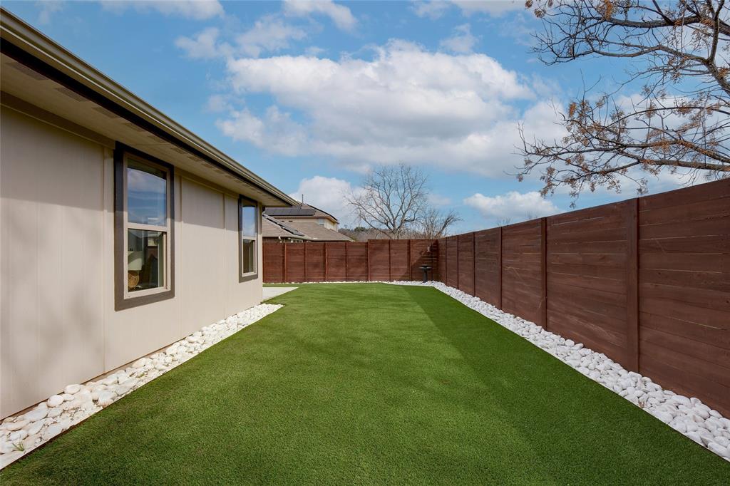 2513 Winchell Lane Austin, TX 78725 - Photo 15 of 23 a view of a backyard with wooden fence