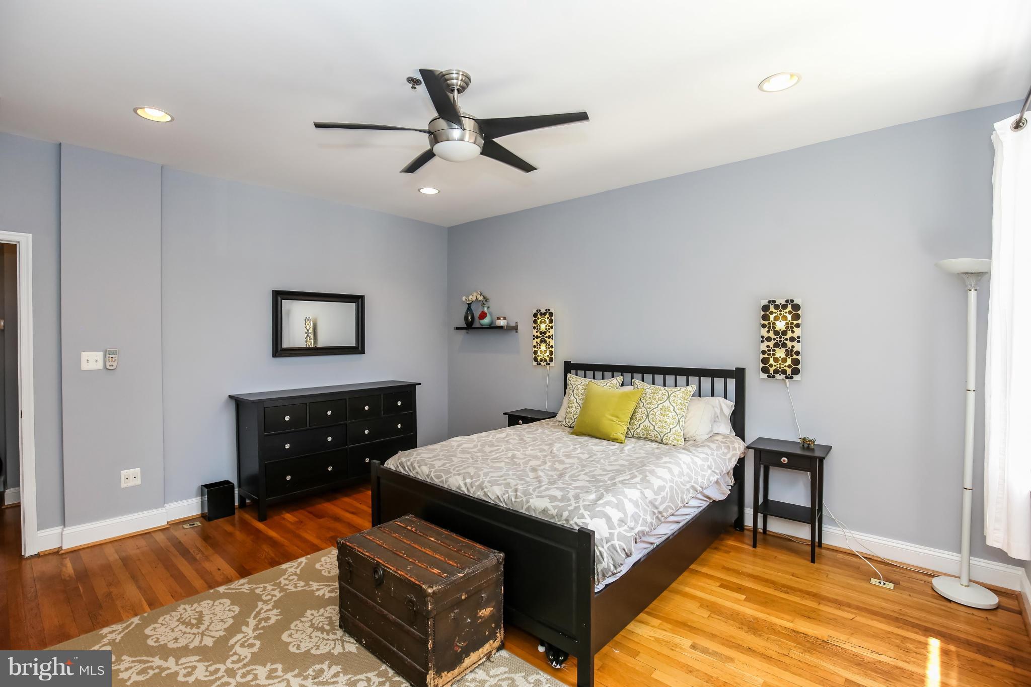 1438 Columbia Road Northwest, Unit 402 Washington, DC 20009 - Photo 11 of 12 a bedroom with a bed and a chandelier