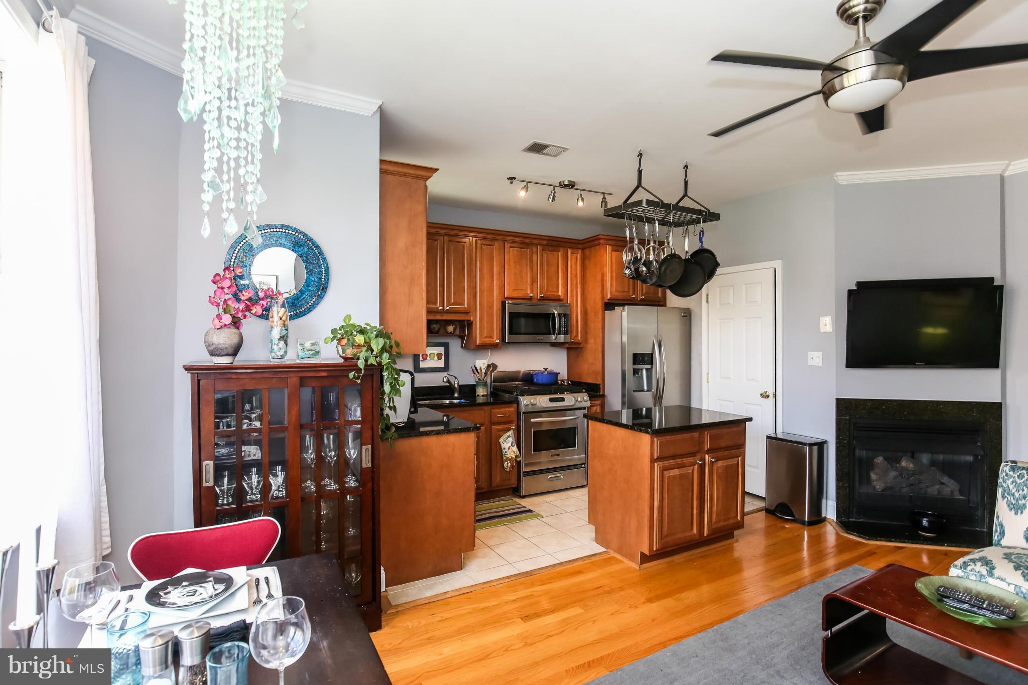 1438 Columbia Road Northwest, Unit 402 Washington, DC 20009 - Photo 5 of 12 a living room with furniture a flat screen tv and a fireplace