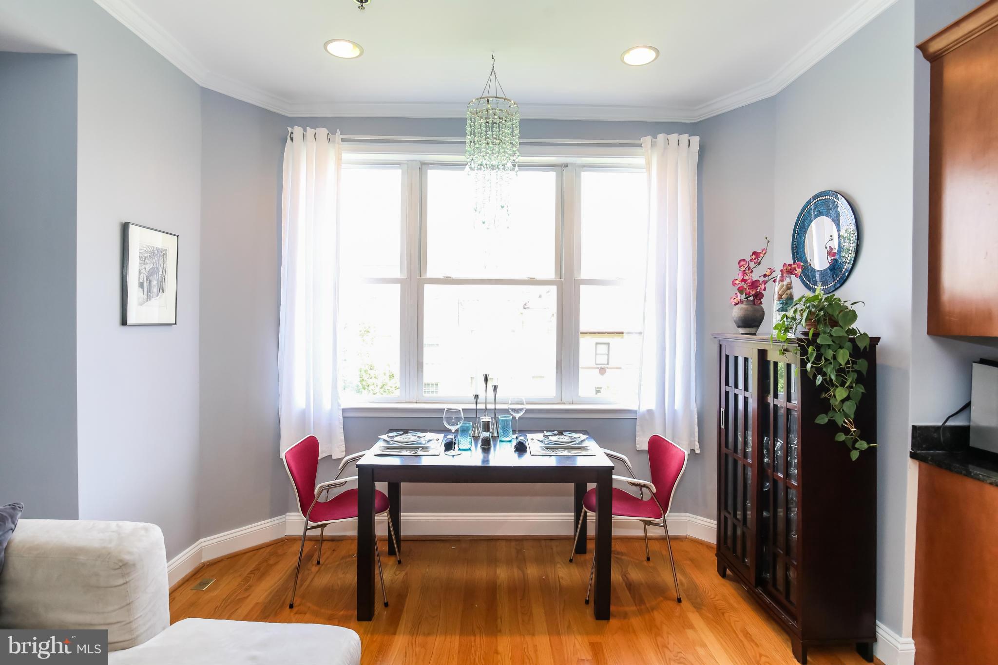 1438 Columbia Road Northwest, Unit 402 Washington, DC 20009 - Photo 7 of 12 a living room with furniture and a large window