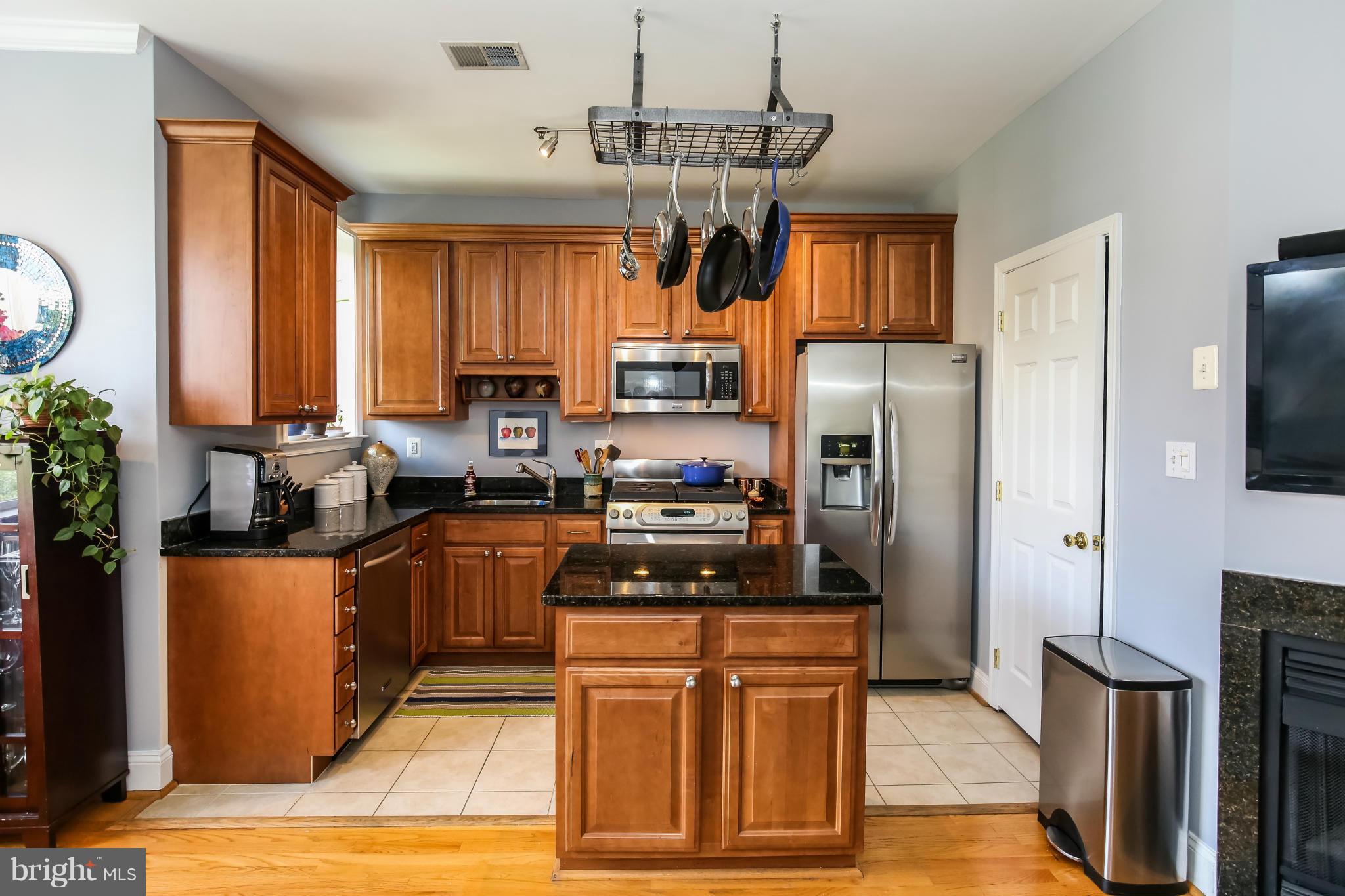 1438 Columbia Road Northwest, Unit 402 Washington, DC 20009 - Photo 9 of 12 a kitchen with stainless steel appliances granite countertop a refrigerator a stove a sink dishwasher and a microwave