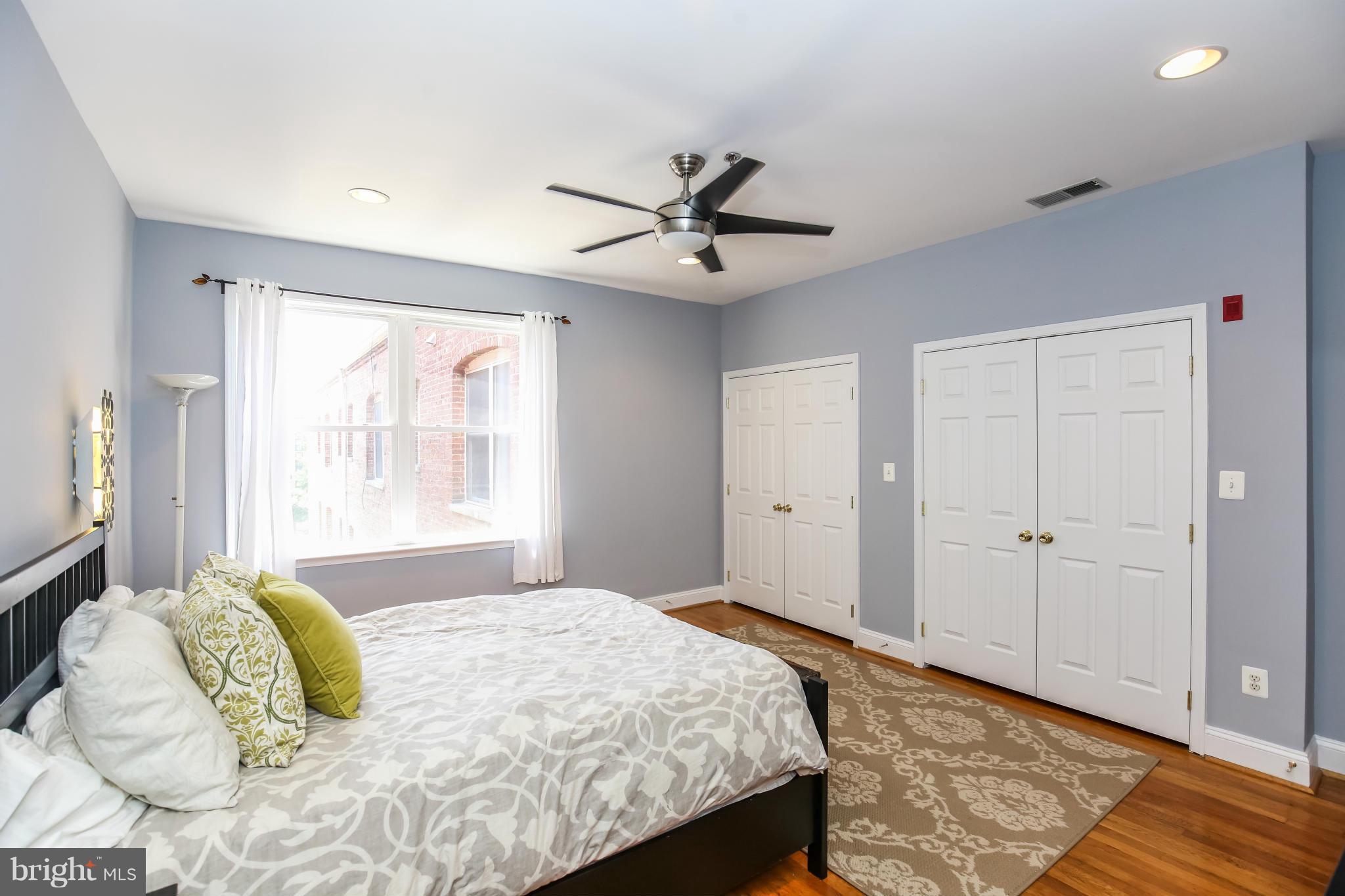 1438 Columbia Road Northwest, Unit 402 Washington, DC 20009 - Photo 10 of 12 a bedroom with a bed and a window