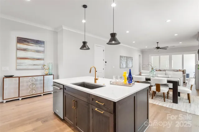 a kitchen that has a lot of cabinets in it and wooden floors