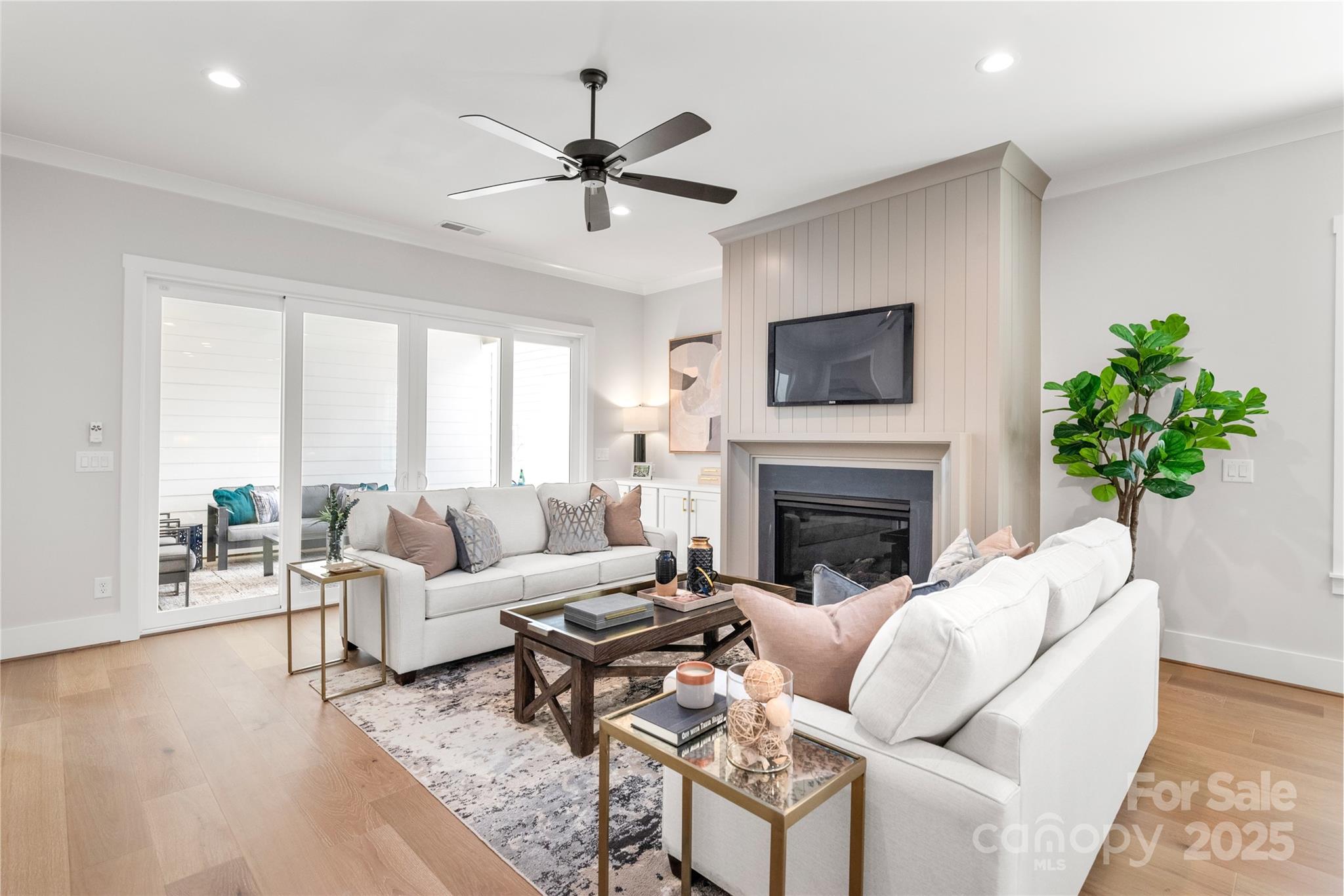 19028 Newburg Hill Road, Unit 22 Davidson, NC 28036 - Photo 16 of 44 a living room with furniture a fireplace and a flat screen tv