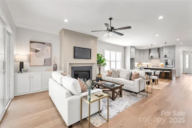 a living room with furniture a fireplace and a flat screen tv