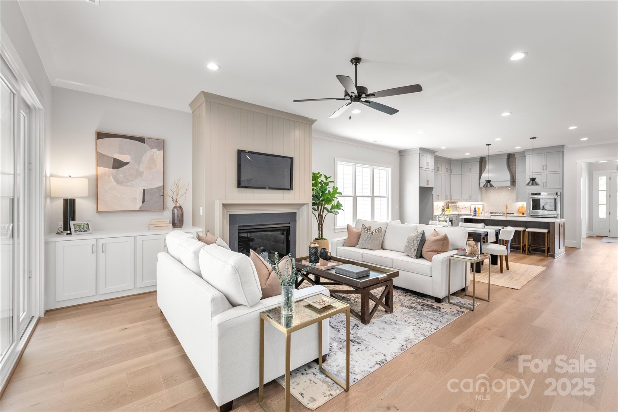 19028 Newburg Hill Road, Unit 22 Davidson, NC 28036 - Photo 17 of 44 a living room with furniture a fireplace and a flat screen tv