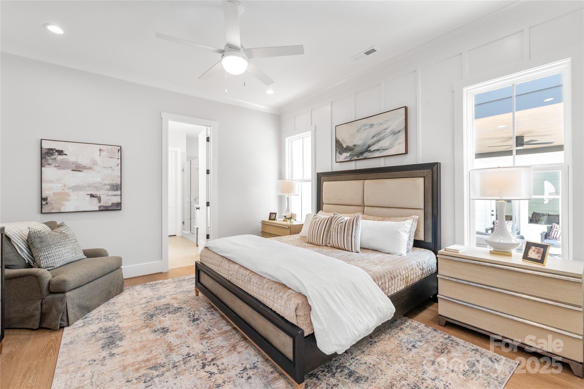 19028 Newburg Hill Road, Unit 22 Davidson, NC 28036 - Photo 18 of 44 a bedroom with a large bed couch and two windows