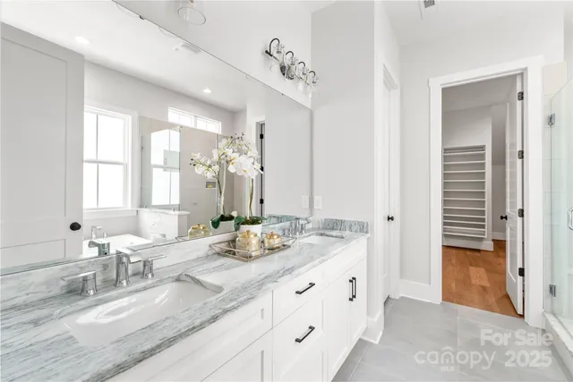 a spacious bathroom with a granite countertop sink and a mirror