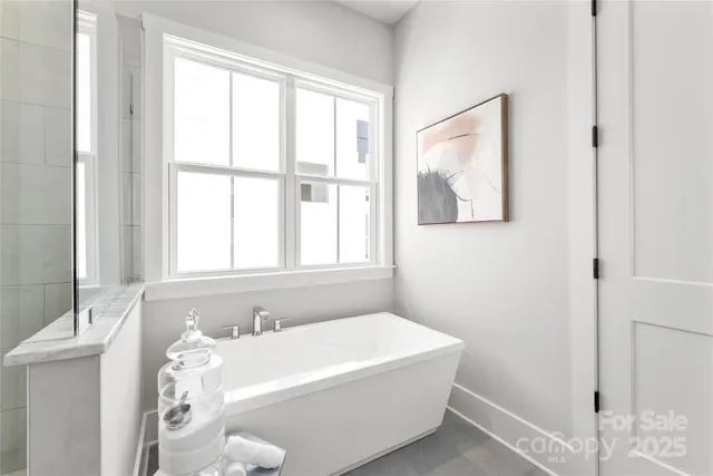 a white bath tub sitting next to a white sink
