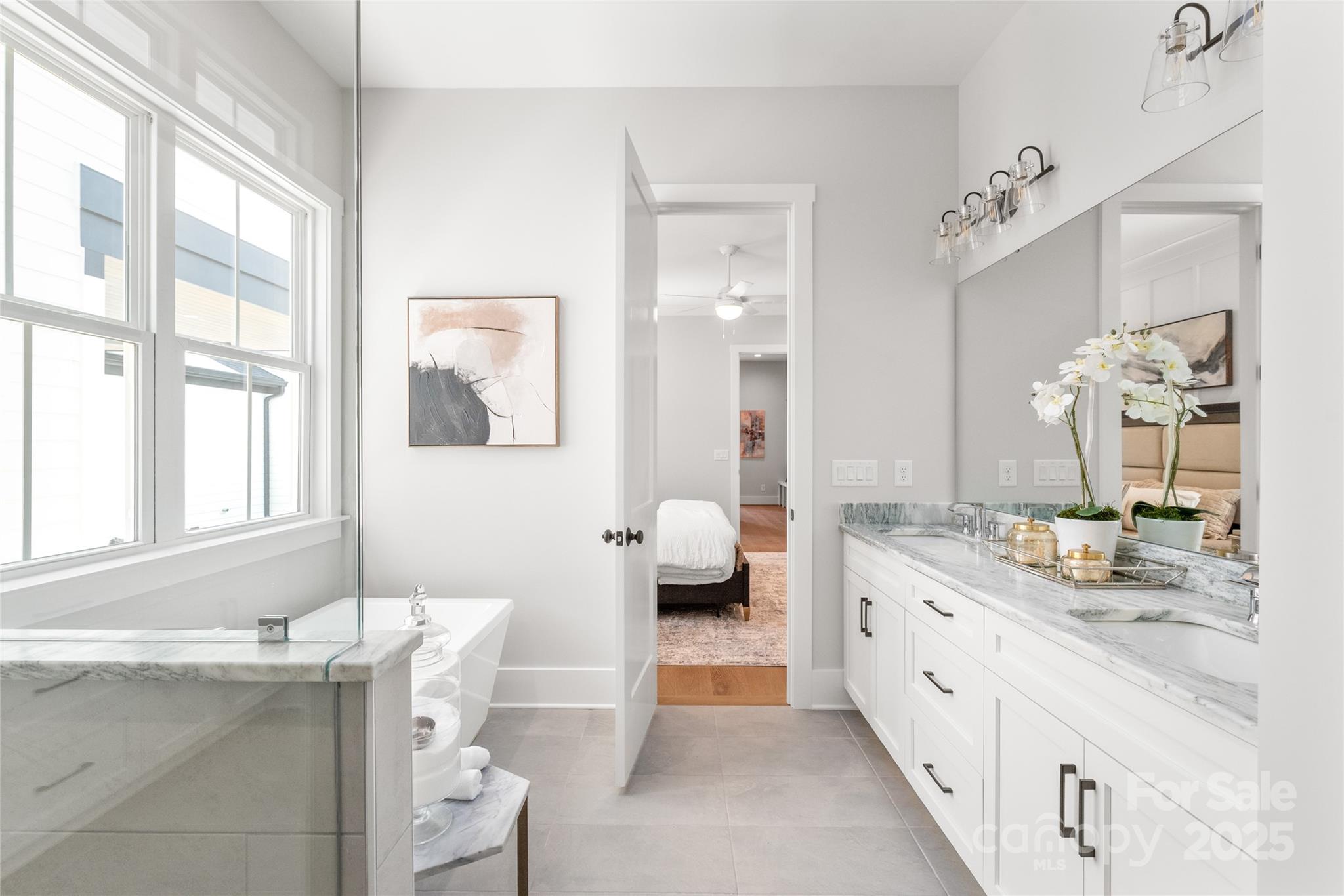 19028 Newburg Hill Road, Unit 22 Davidson, NC 28036 - Photo 22 of 44 a spacious bathroom with a granite countertop double vanity sink a mirror and a bathtub