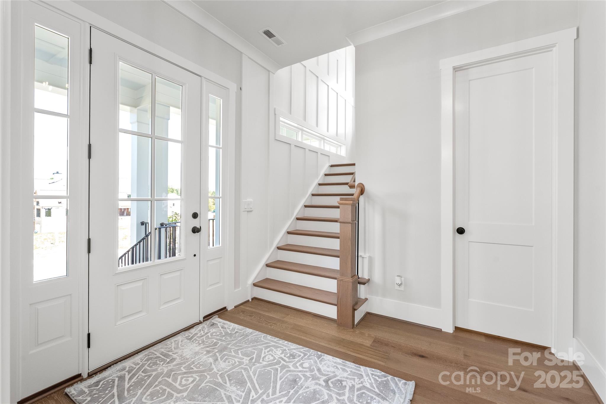 19028 Newburg Hill Road, Unit 22 Davidson, NC 28036 - Photo 28 of 44 a view of a livingroom with wooden floor and stairs