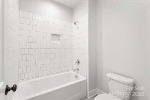 a bathroom with a bathtub and toilet