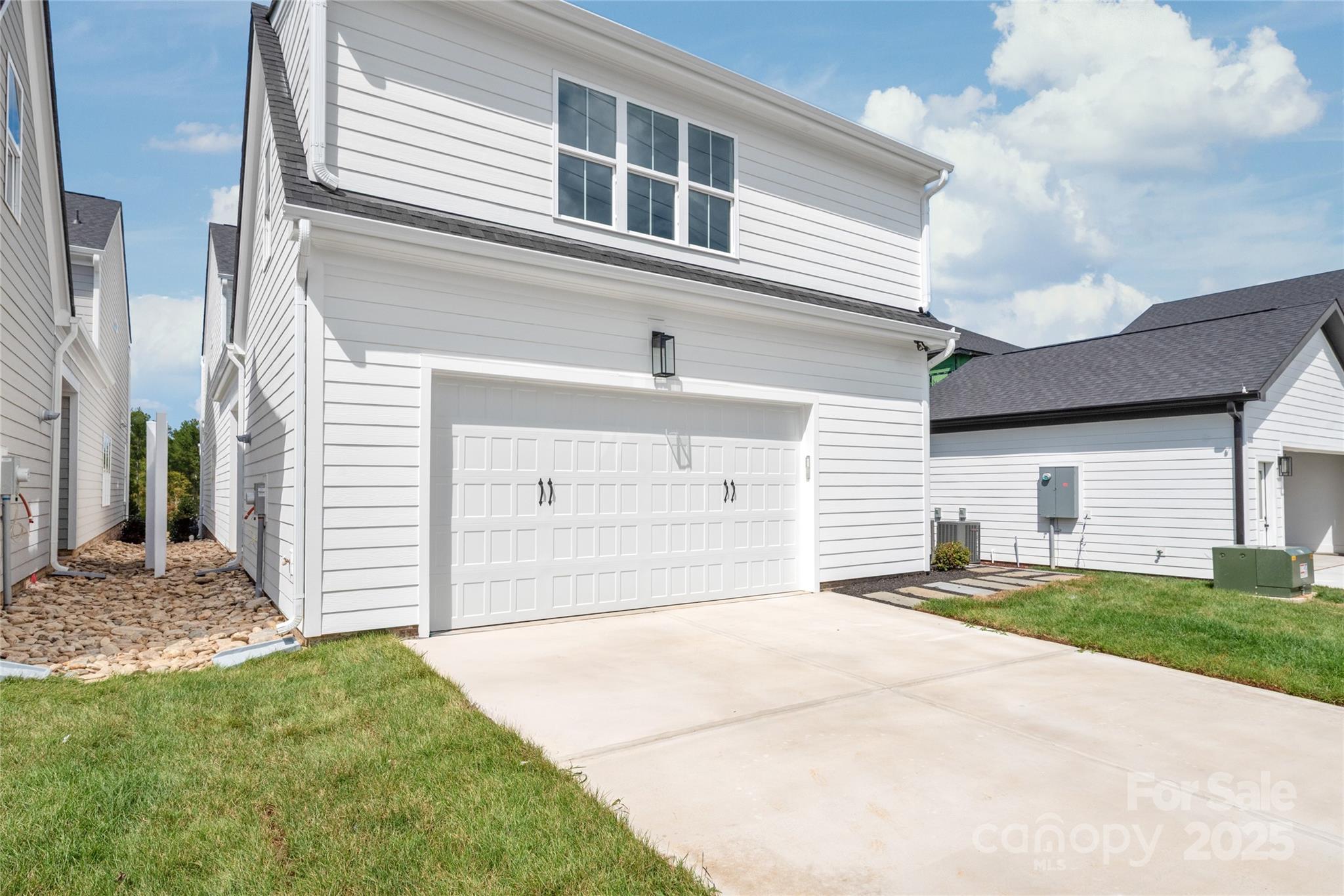 19028 Newburg Hill Road, Unit 22 Davidson, NC 28036 - Photo 44 of 44 a front view of a house with a yard and garage