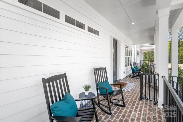a view of a chairs and table in the balcony