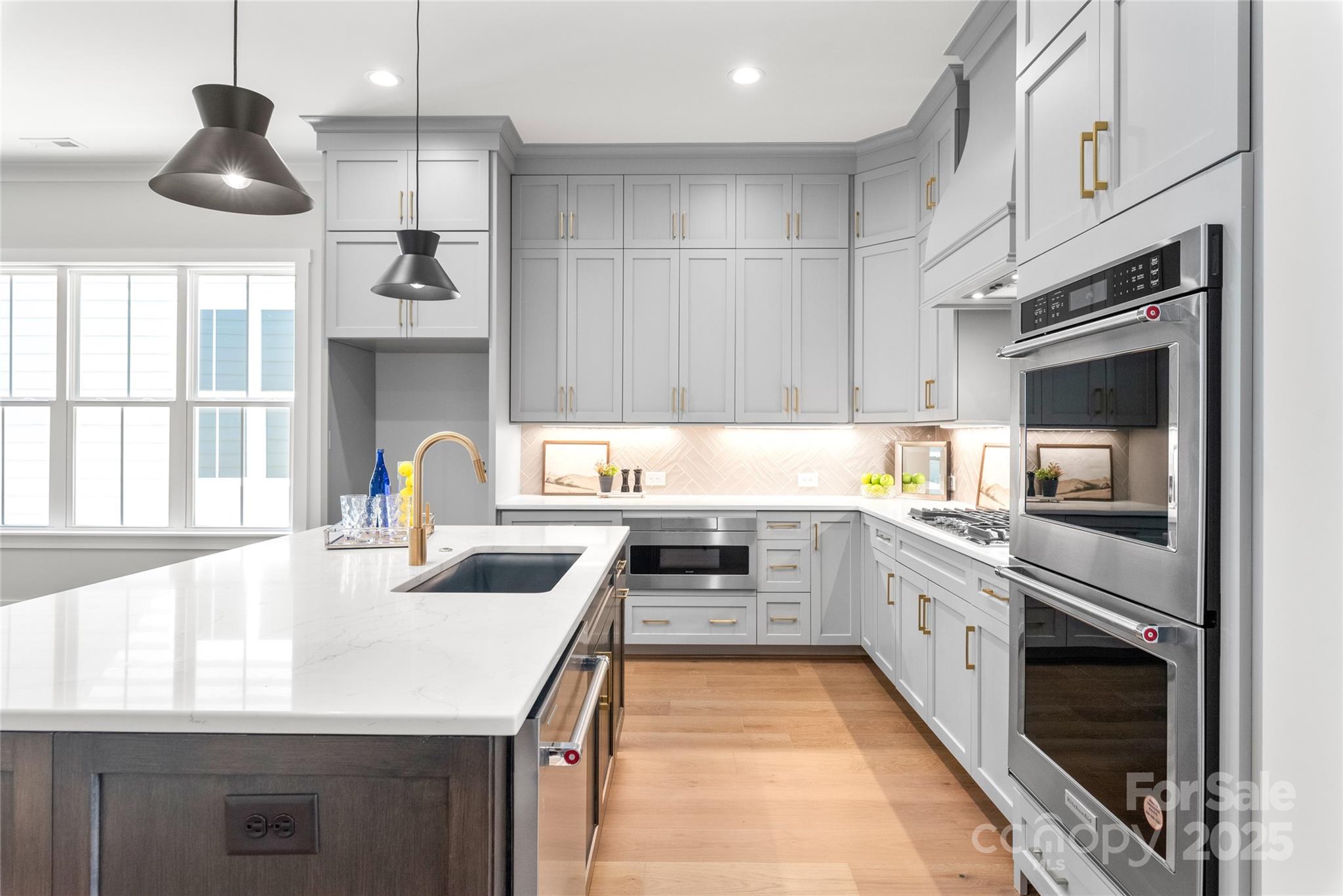 19028 Newburg Hill Road, Unit 22 Davidson, NC 28036 - Photo 10 of 44 a kitchen with stainless steel appliances granite countertop a sink and a stove
