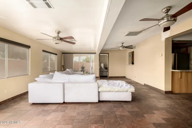 a living room with a couch and a ceiling fan