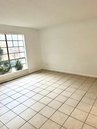 a view of an empty room and a window