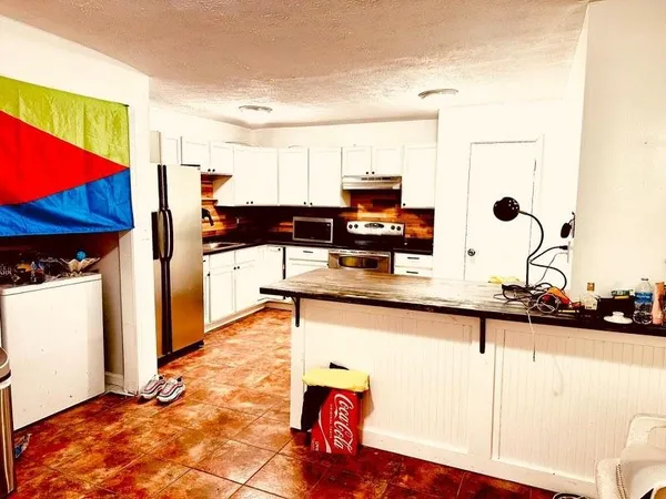 a kitchen with stainless steel appliances kitchen island granite countertop a sink and cabinets