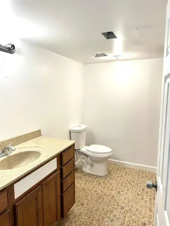 a bathroom with a sink a toilet and a mirror