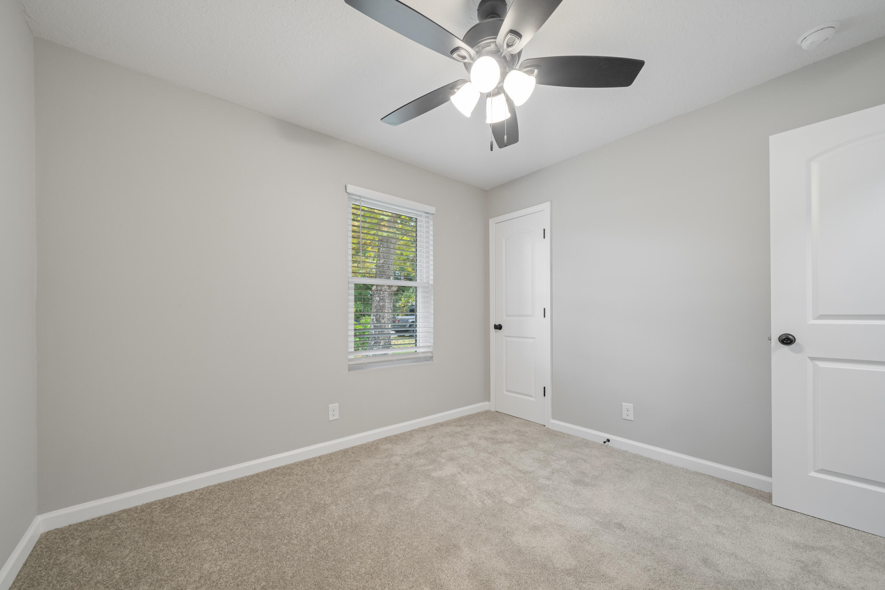 37 Beech Lane DeFuniak Springs, FL 32435 - Photo 16 of 26 an empty room with a chandelier fan and windows