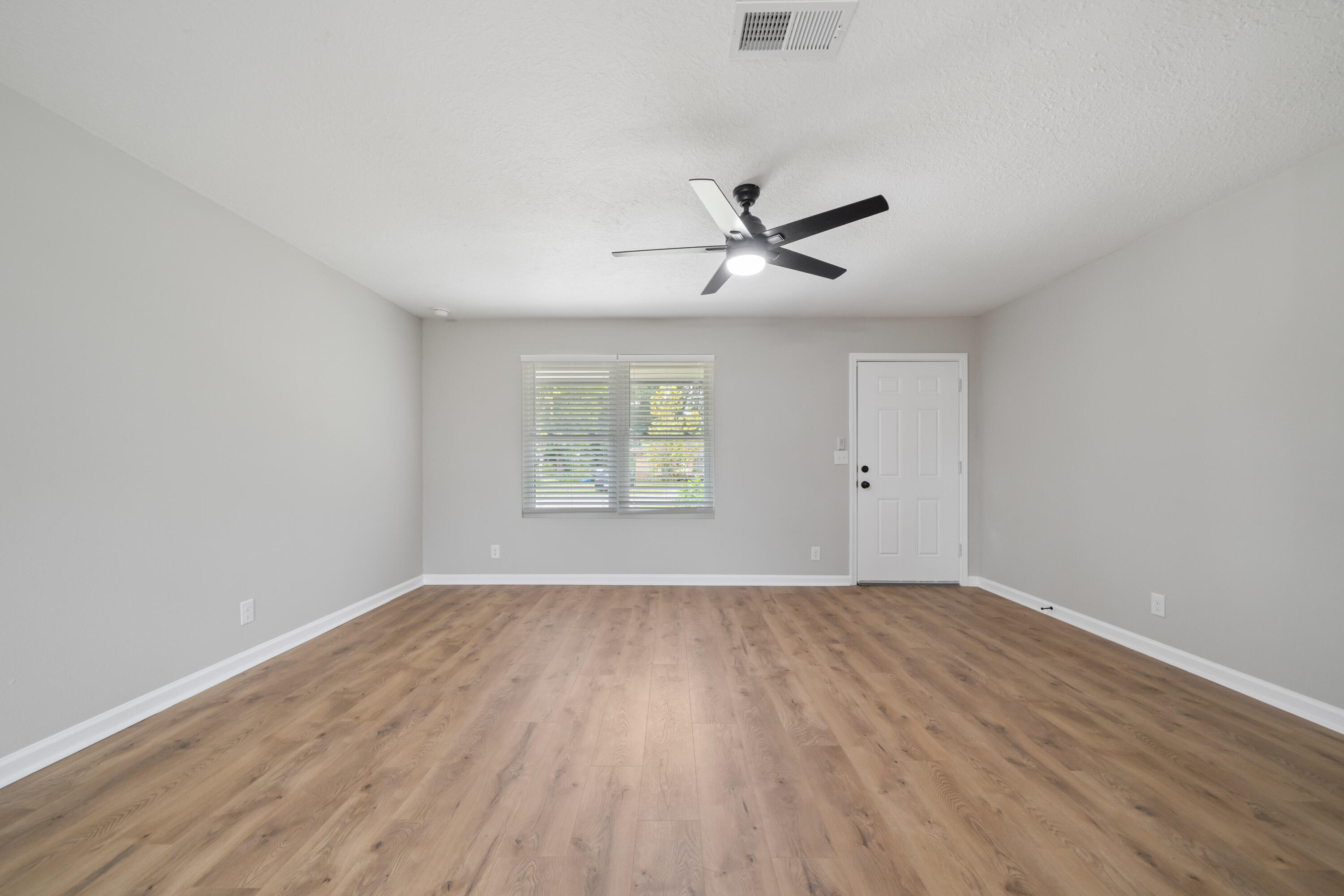 37 Beech Lane DeFuniak Springs, FL 32435 - Photo 8 of 26 an empty room with wooden floor and windows