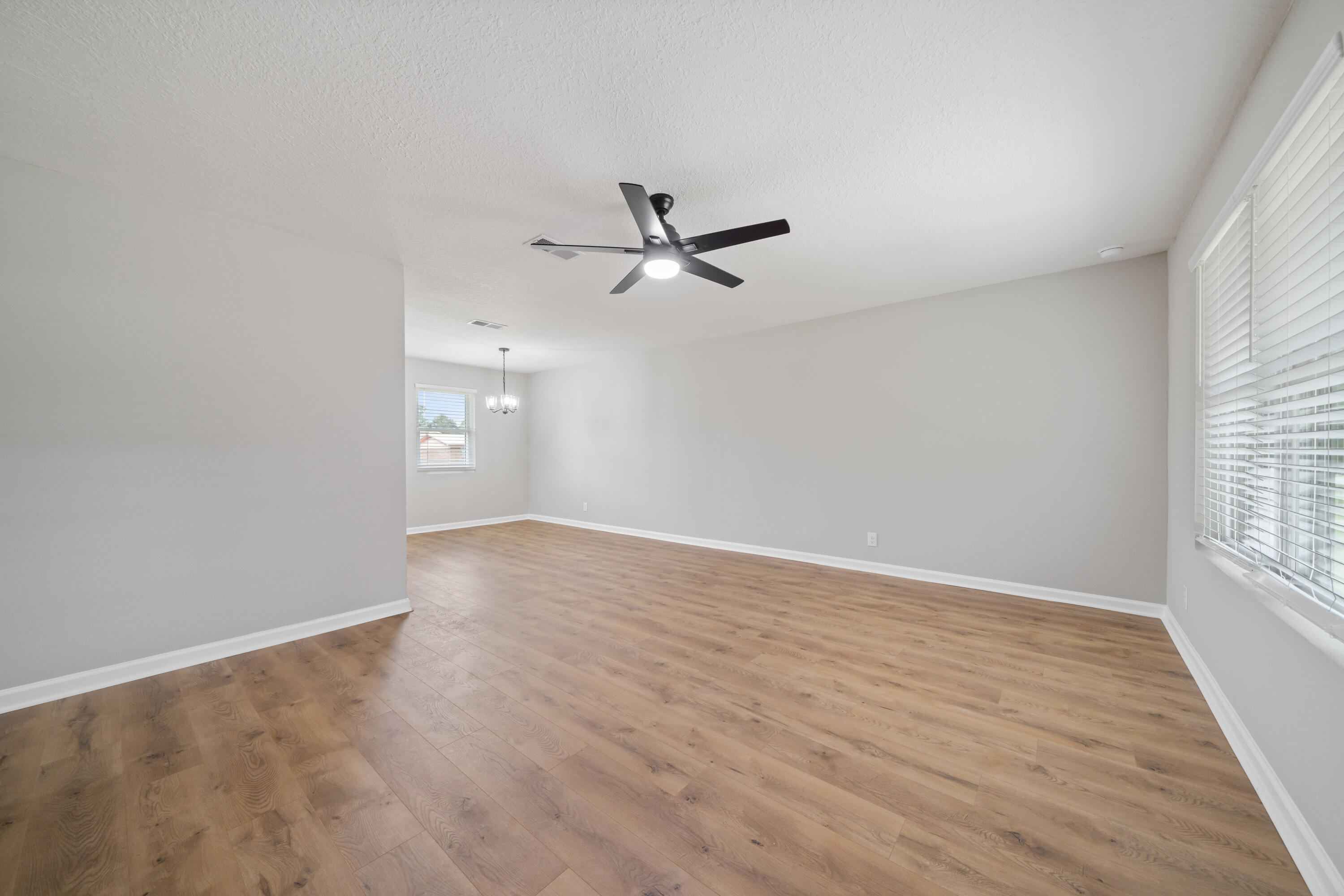 37 Beech Lane DeFuniak Springs, FL 32435 - Photo 9 of 26 an empty room with wooden floor and ceiling fan