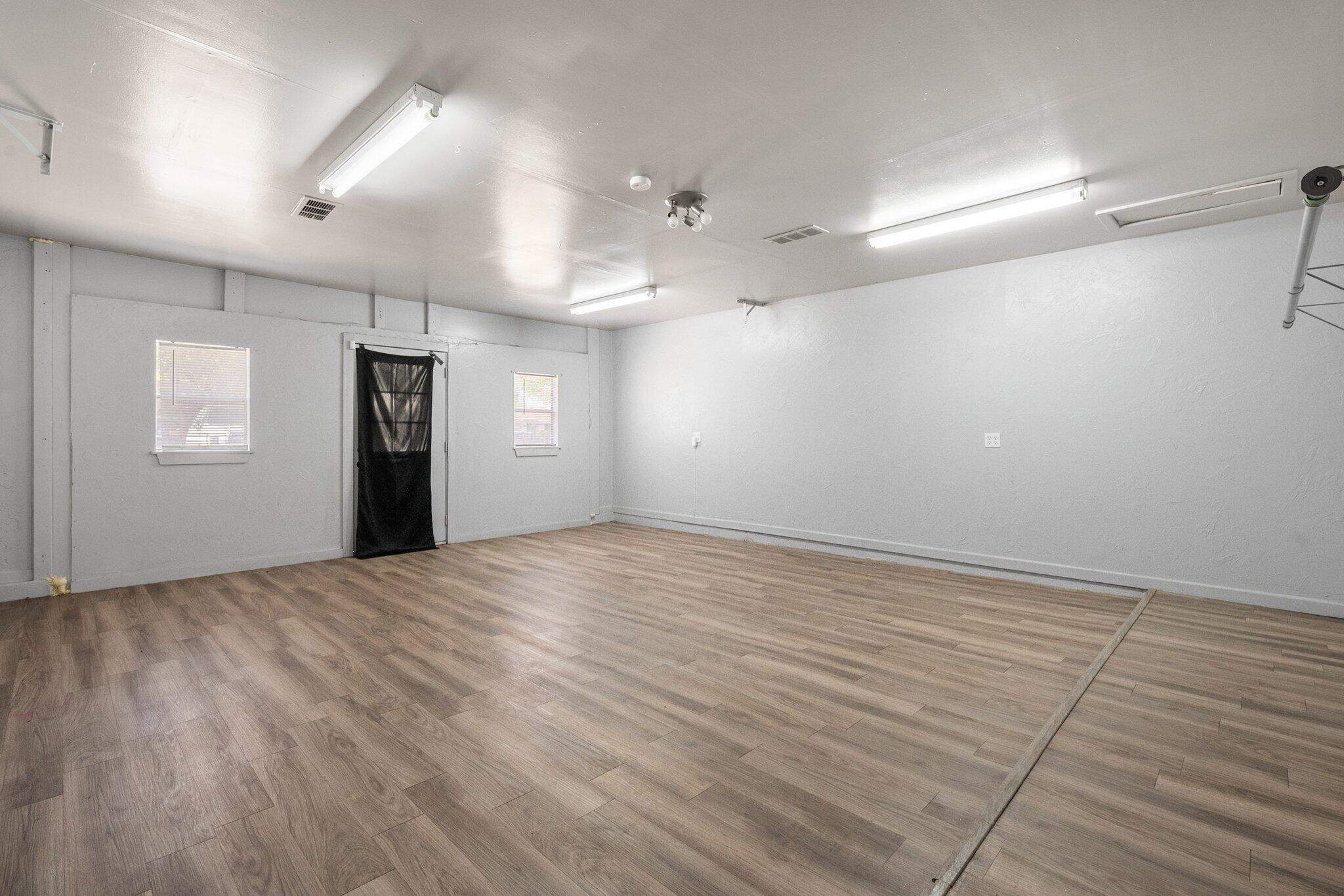 2319 53rd Street Lubbock, TX 79412 - Photo 15 of 20 an empty room with wooden floor and windows