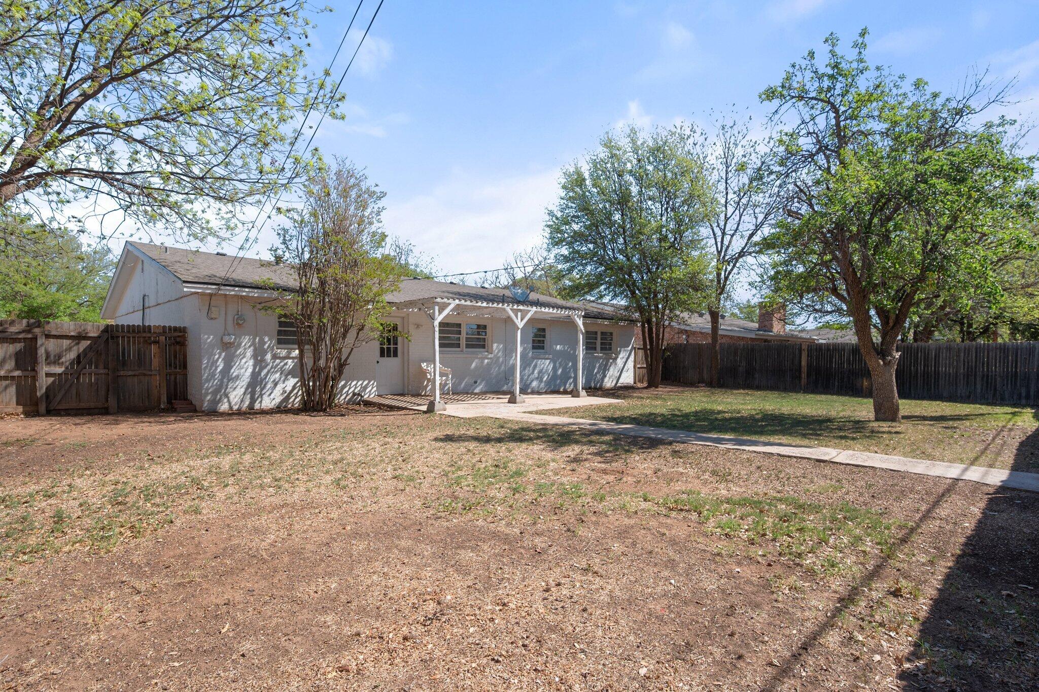 2319 53rd Street Lubbock, TX 79412 - Photo 18 of 20 a front view of a house with a yard and garage