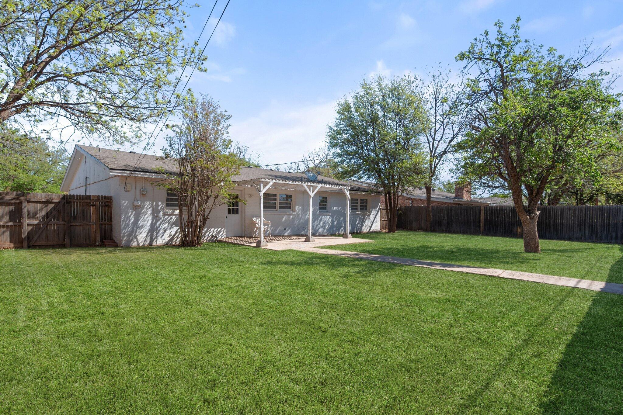 2319 53rd Street Lubbock, TX 79412 - Photo 19 of 20 a front view of house with yard and green space