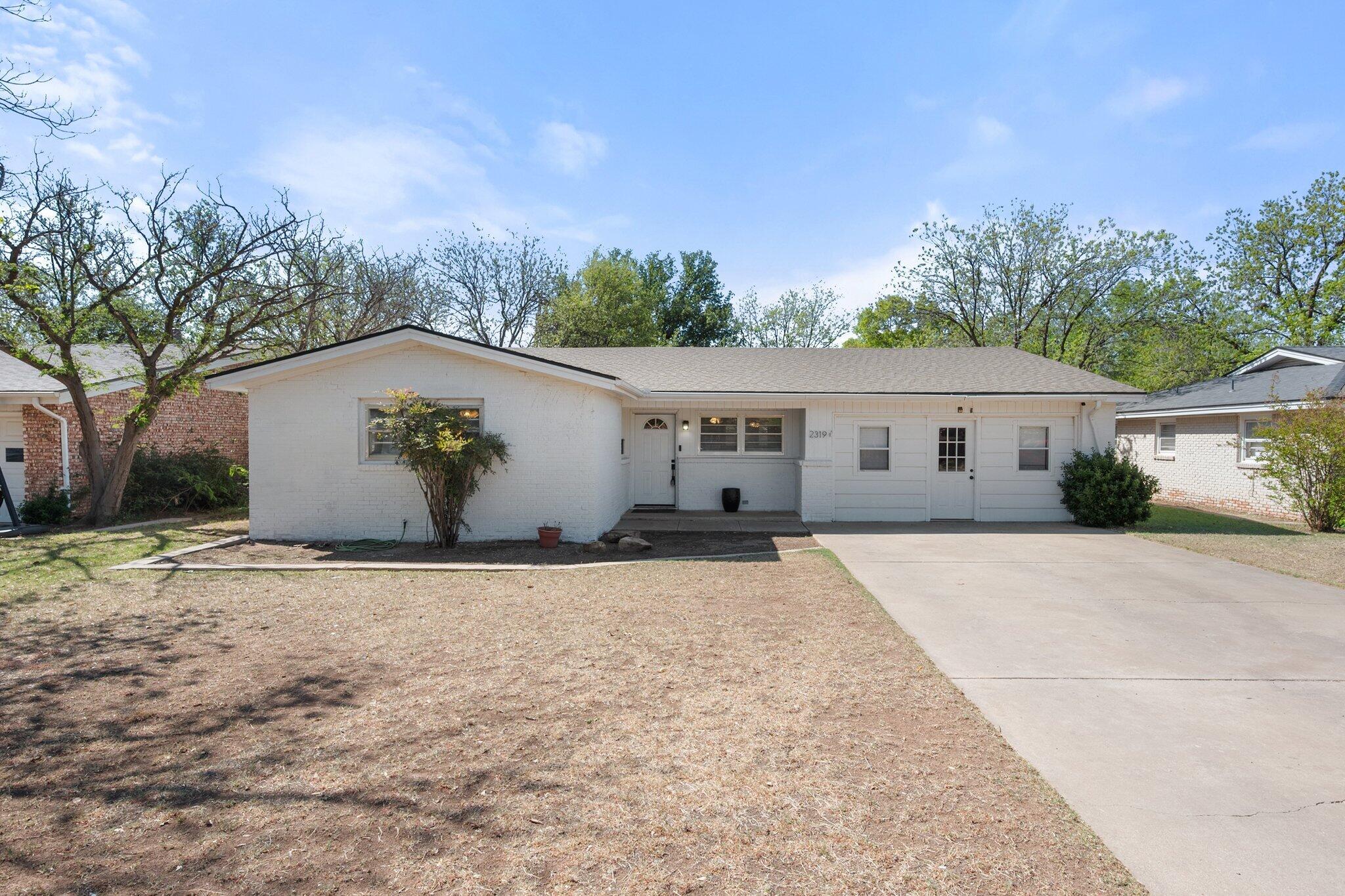 2319 53rd Street Lubbock, TX 79412 - Photo 3 of 20 a house with trees in the background
