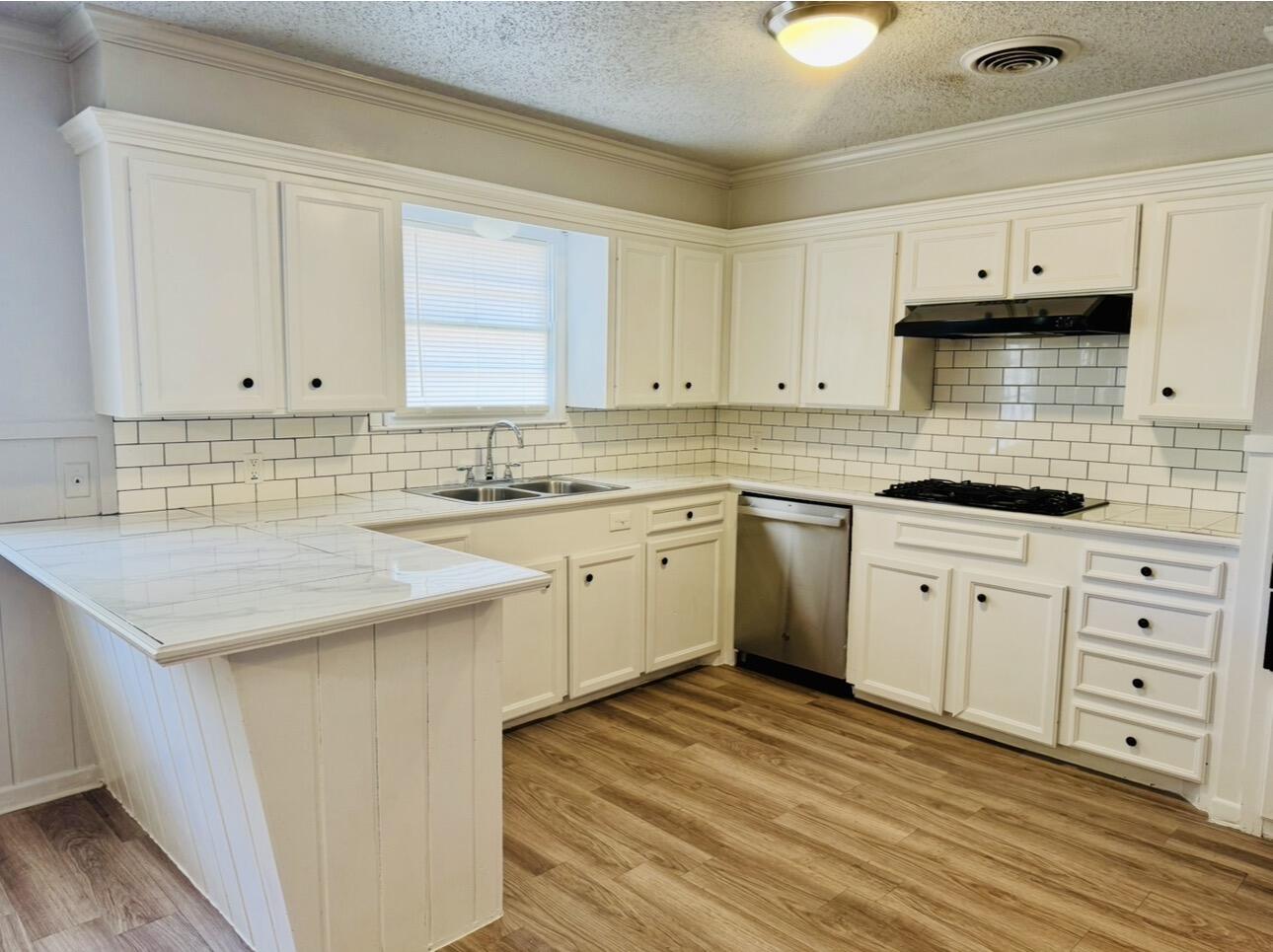 2319 53rd Street Lubbock, TX 79412 - Photo 7 of 20 a kitchen with stainless steel appliances granite countertop a sink stove and cabinets