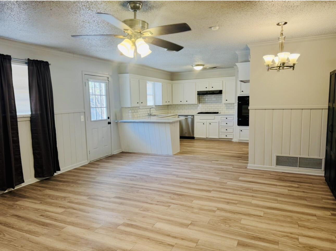 2319 53rd Street Lubbock, TX 79412 - Photo 8 of 20 a view of kitchen and empty room with wooden floor