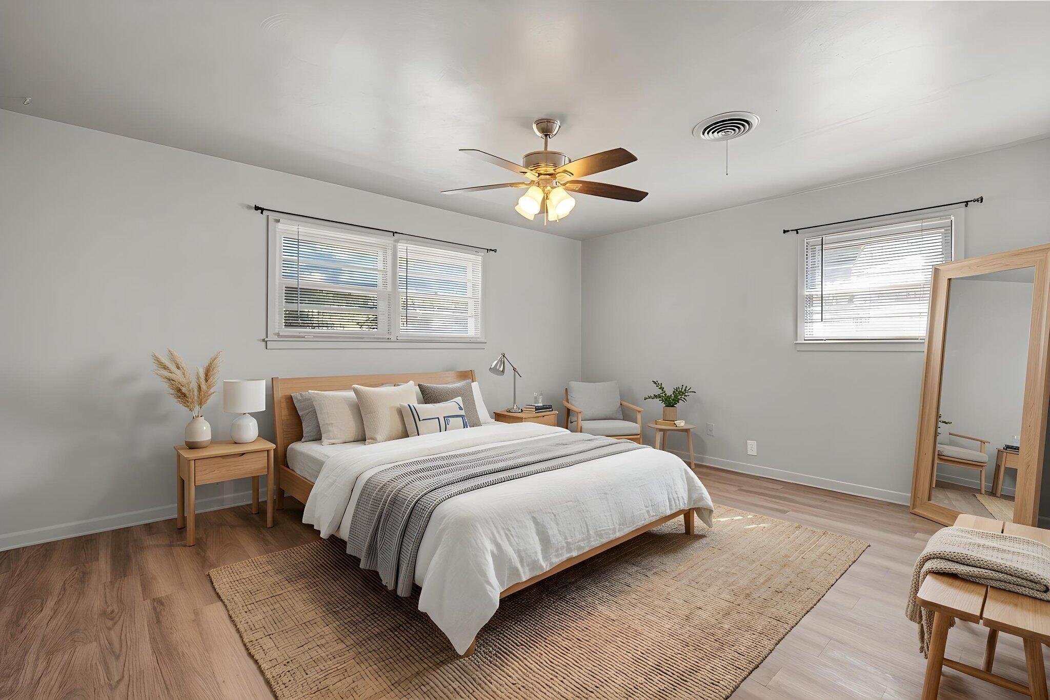 2319 53rd Street Lubbock, TX 79412 - Photo 10 of 20 a bedroom with a bed and a chandelier