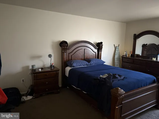 a bedroom with a bed and dresser
