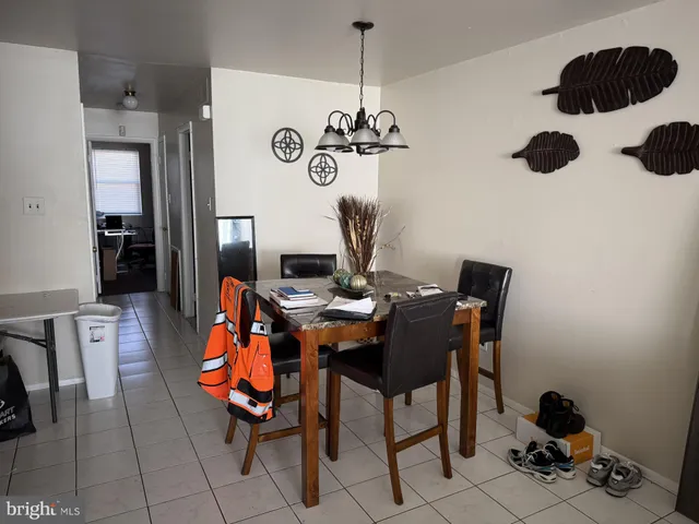 a view of a workspace with furniture and chandelier