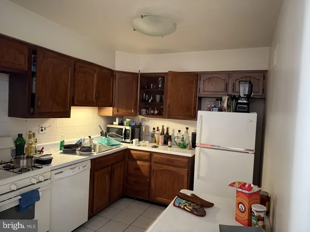 a kitchen with sink a refrigerator and cabinets