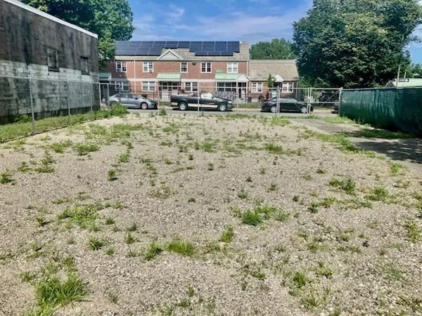 a backyard of a house with lots of green space and fountain