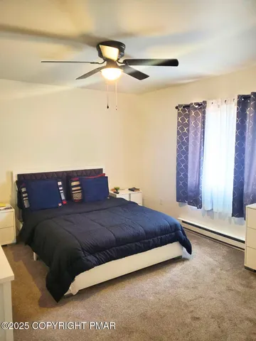 a bedroom with a bed and a night stand