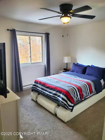 a spacious bedroom with a bed and a chandelier